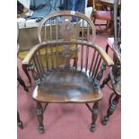An Ash Elm Windsor Chair, with a hooped back, pierced splat, rail supports on turned legs, united by