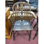 An Ash Elm Windsor Chair, with a hooped back, pierced splat, rail supports, on turned legs united by