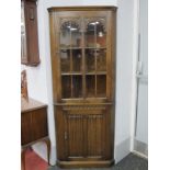 XX Century Oak Corner Cupboard, with arched glazed doors over linenfold cupboard door.