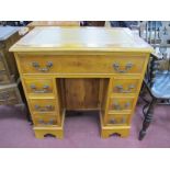 A Yew Wood Kneehole Desk, with crossbanded top, gold scriver over long drawer, twin pedestals each
