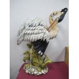 Italian Pottery, Large Figure of Wading Bird, possible a stork, on oval stone effect base, 80.4cm