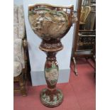 Pottery Jardiniere, with cherub decoration and mask handles, on brown marbulette ground; together