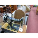 Singer Sewing Machine, in domed case, an uncased example. (2)