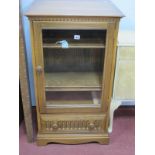 Ercol Hi-Fi Cabinet, with glazed door, drawer with knulled decoration, on bracket feet.