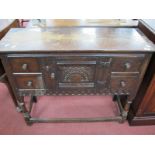 A XX Century Oak Cabinet, with flanking drawers, arched middle cupboard door, on turned and block