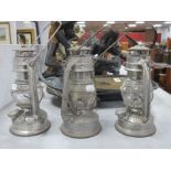 'Kwng Hwa' Chinese Hurricane Lamps, each 18.5cm high with handle down. (3)