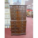 A XX Century Mahogany Serpentine Shaped Tallboy, with a dentil cornice, eight long drawers, on