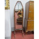 A Mahogany Cheval Mirror, with an arched top, tapering supports on cabriole legs.