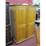 A Small Pine Wardrobe, with twin panelled doors, on turned feet.