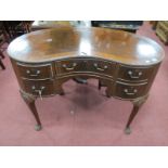 A Mahogany Kidney Shaped Dressing Table, central drawer, flanking drawers on cabriole legs, pad