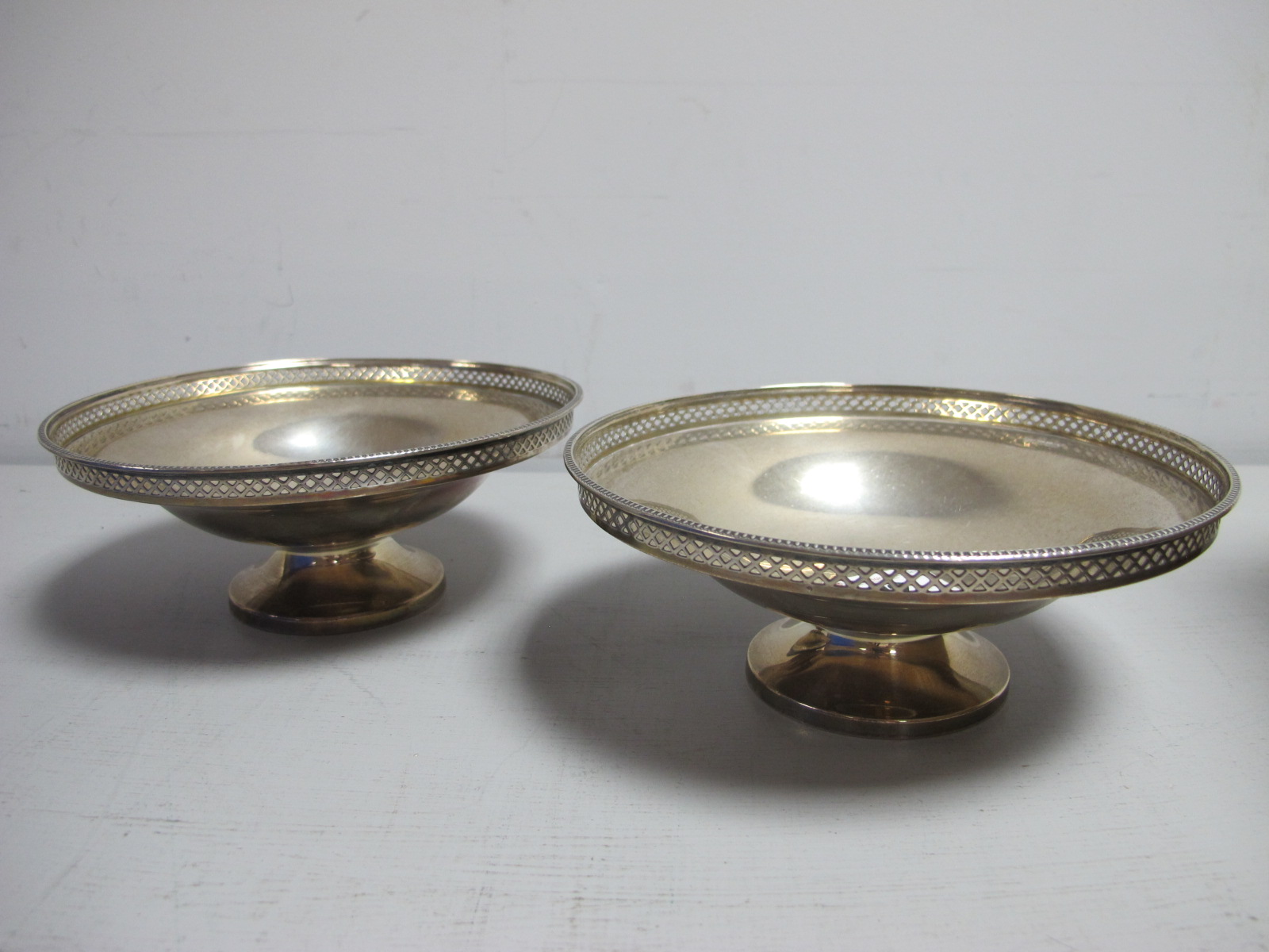 A Pair of Hallmarked Dishes, Walker & Hall, Sheffield 1925, each of plain circular form with