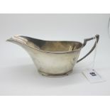 A Hallmarked Silver Sauce Boat, Walker & Hall, Sheffield 1929, of plain design, with pointed loop