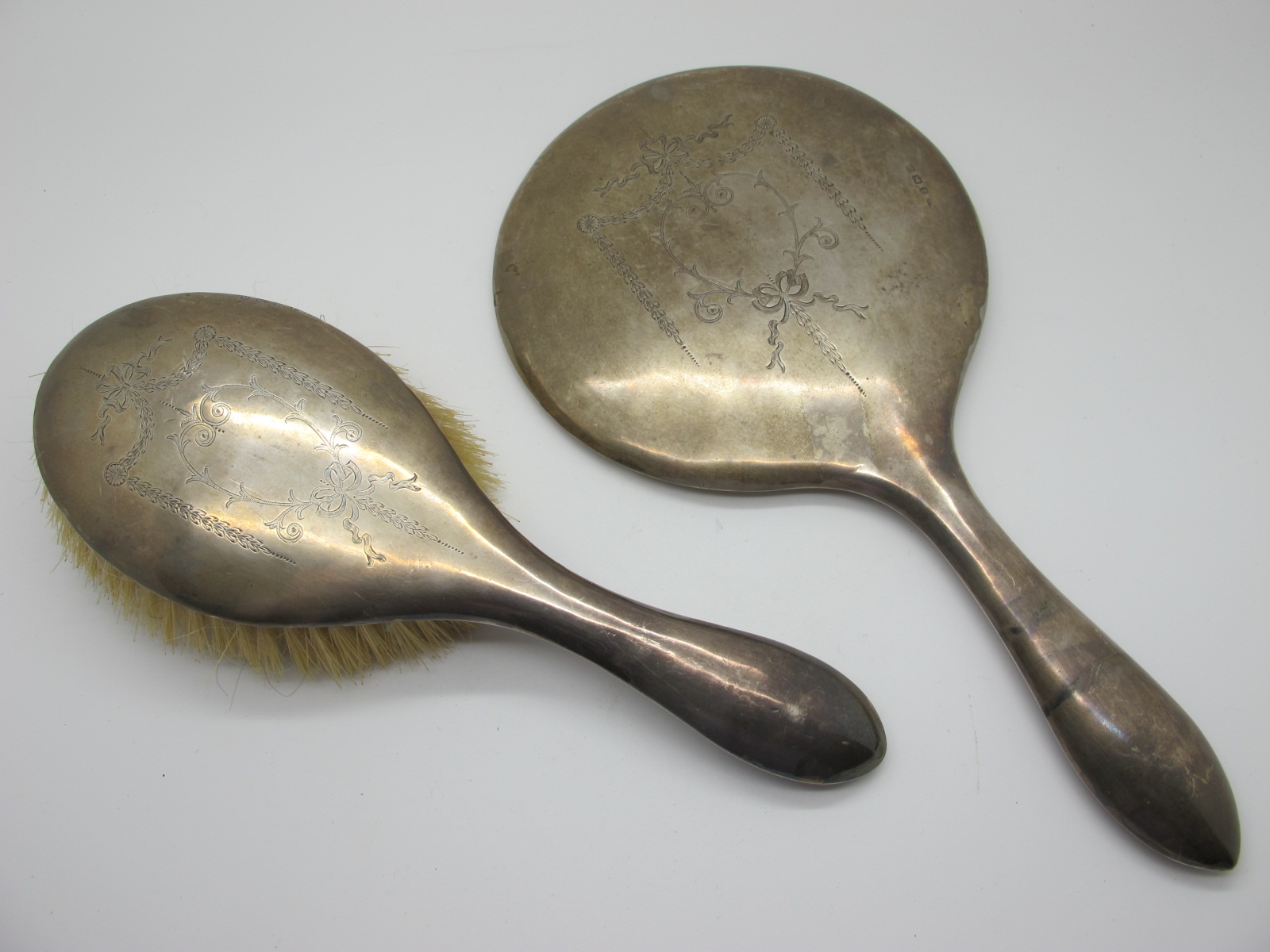 A Matching Hallmarked Silver Backed Hand Mirror and Hair Brush, WA, Birmingham 1913, each detailed