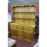 Pine Dresser, with planked rack, six various drawers and two cupboard doors to base, 137cm.