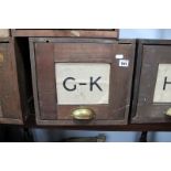 An Early 1900's Pine Factory Shop Filing Cabinet, with original labels and brass cup handle, (