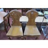 A Pair of Late XIX Century Pine Hall Chairs, each with carved and scroll back on cabriole legs.