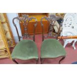 pair of Early XX Century walnut Single Chairs. with scroll work carving, pierced splat back on