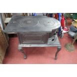 Cast Iron Wood Burning Freestanding Stove, having pin stands on cabriole legs, 66cm wide.