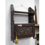 Late XIX Century Stained Beech Wall Rack, having single shelf over carved cupboard door, carved