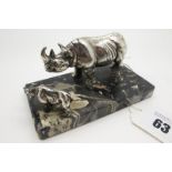 An Art Deco Style Desk Paperweight, modelled with two rhinoceros, on mottled hardstone plinth