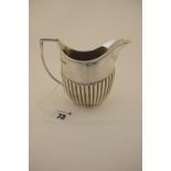 A Hallmarked Silver Jug, Roberts & Belk, Sheffield 1906, of plain oval semi reeded form, with