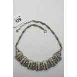 Esha Randel; An Art Deco Necklace, composed to the front of claw set bars, set throughout with