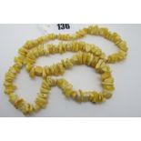 A Single Strand Graduated Pale Amber Coloured Tumbled Bead Necklace, approximately 60cm long.