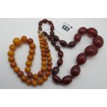 A Single Strand Graduated Amber Coloured Bead Necklace, 36.5cm long; together with a single strand