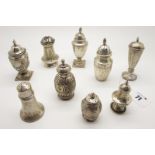 A Collection of Nine Hallmarked Silver Pepperettes, (various makers/dates), tallest 9.2cm (