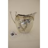 A Hallmarked Silver Jug, JD&S, Sheffield 1904, of shaped oval form leaf scroll detailed in relief,