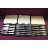 Three Sets of Six Hallmarked Silver Handled Tea Knives, two sets with ribbon and reed decoration, in