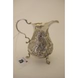 A Hallmarked Silver Cream Jug, London 1744, of baluster form, allover detailed in relief with leaf