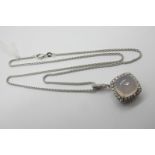 A Modern 18ct White Gold Rose Quartz and Diamond Set Pendant, of cushion shape, high cabochon set to