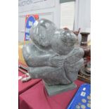 The Embrace, carved mineral modernist sculpture, possibly marble/soapstone, on square slate base,