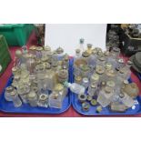 A Large Quantity of glass condiment, scent and tidy bottles:- Two Trays