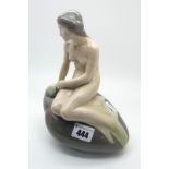 A Royal Copenhagen Porcelain Figure of 'The Little Mermaid', seated on a rock, printed and painted