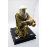 A Royal Worcester Porcelain Figure of a Water Carrier, the kneeling lady in a gilt flowing robe