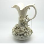 A Belleek Porcelain Jug, of part fluted form, richly encrusted with flowers, the lower section