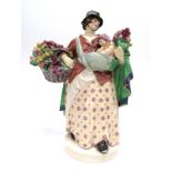 A Charles Vyse Pottery Figure 'Tulip Woman', holding a basket and bunch of tulips, circular base,