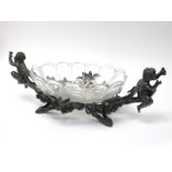 A Late XIX Century Christofle Table Centrepiece, the plated oval stand with two putti amongst