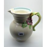 A Newport Pottery 'Clarice Cliff' Jug, of globular form, the handle with flower surmount, the