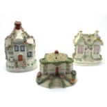 A Mid XIX Century Staffordshire Pottery Money Box, in the form of a cottage, with encrusted