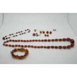A Cherry Amber Coloured Faceted Bead and Wire Necklace, 36cm long; together with an amber coloured