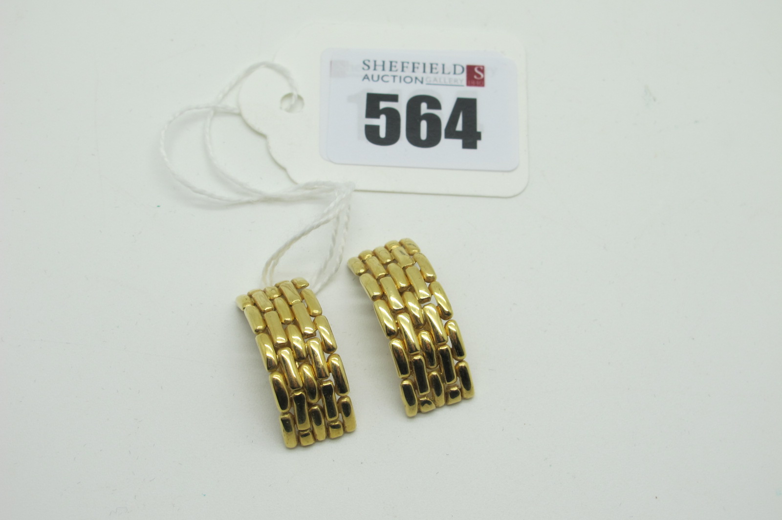 A Pair of Modern Clip Earrings, (unpierced) of uniform brick link curved design, stamped "18ct" (