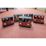 Five Mamod Live Steam Railway Four Wheel Coaches, playworn, damaged, unassociated passengers.