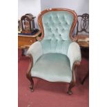 A XIX Century Mahogany Framed Arm Chair, with balloon back, scrolled hand rests, upholstered in a