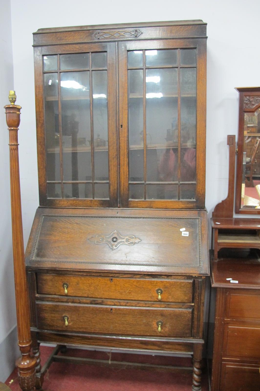 A 1920's Oak Bureau Bookcase with Astragal Glazed Doors, fall front over two drawers on barley twist