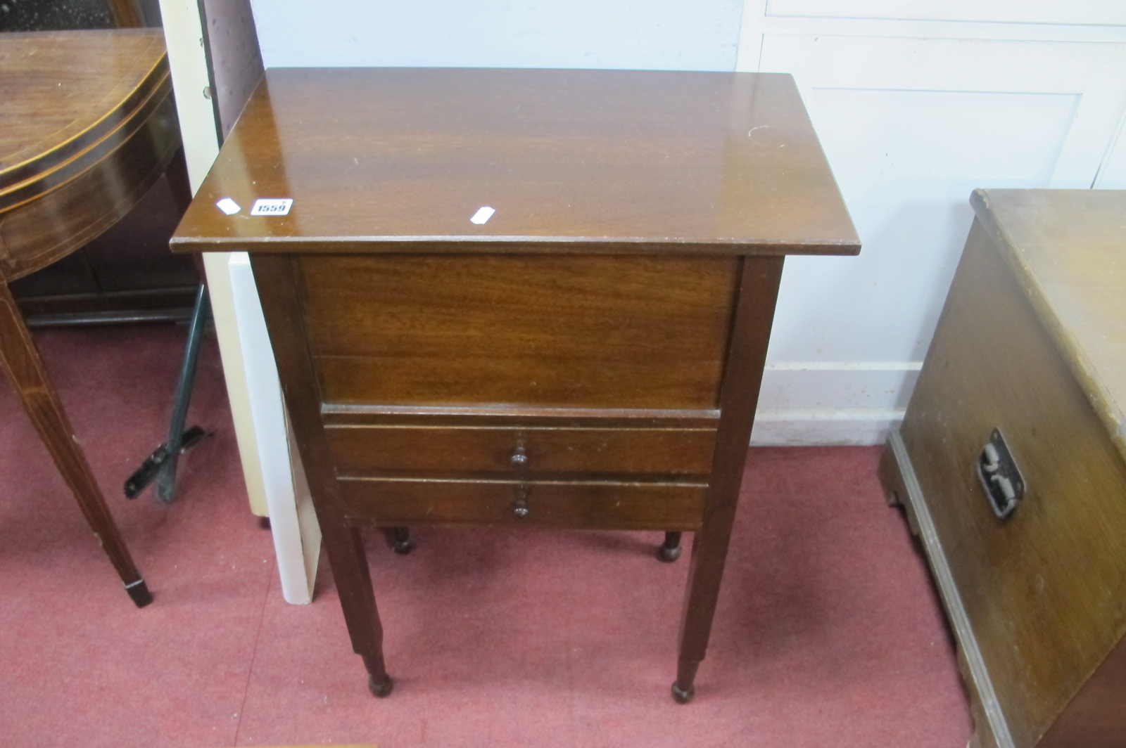 A Mahogany Needlework Cabinet, having lift up top, over two drawers on block legs and turned feet