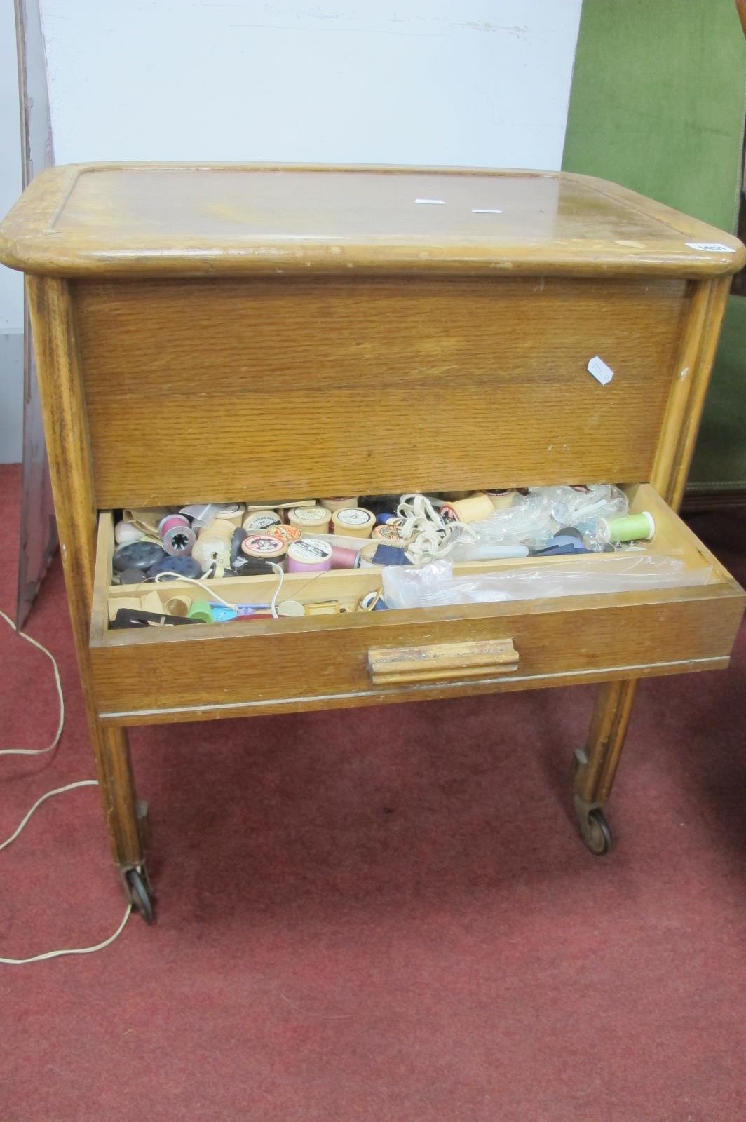 An Early XX Century Oak Needlework Cabinet, with contents.