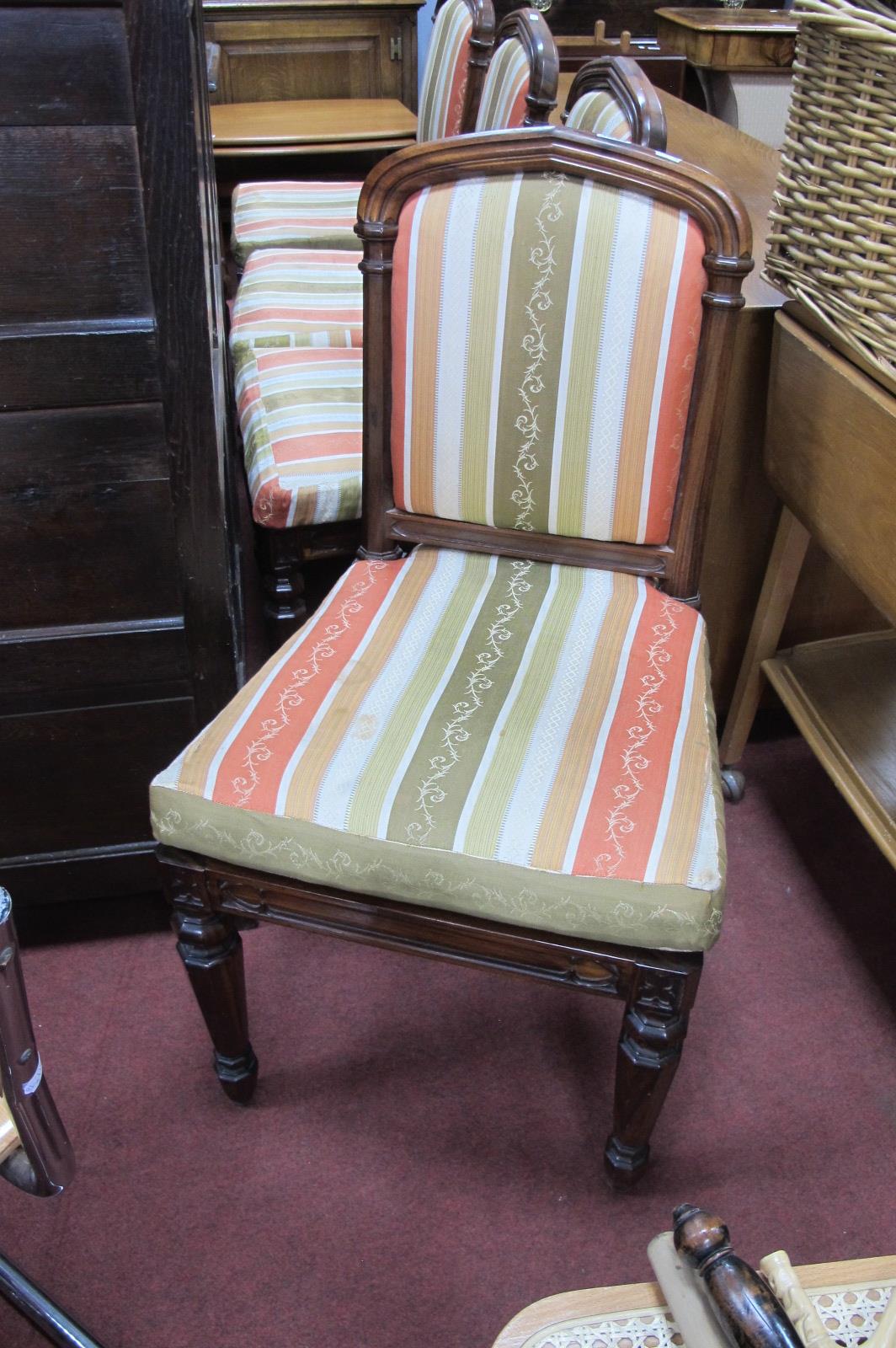 A Set of Four William IV Rosewood Chairs, with reeded top rails, upholstered centre panels and caned